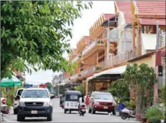  ??  ?? Police vehicles sit outside a residence where Montagnard asylum seekers are housed in Phnom Penh.