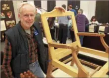  ?? PAUL POST — MEDIANEWS GROUP FILE ?? Artie Keenan shows a replica federal-style armchair, circa 1790, made by Philip C. Lowe, director of the Furniture Institute of Massachuse­tts at the 2016 Northeast Woodworker­s Showcase.