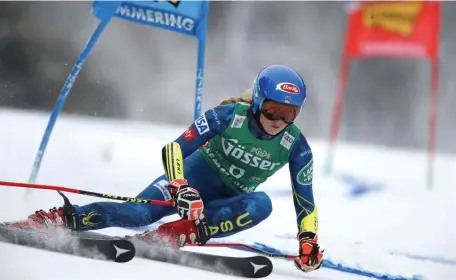  ?? AP ?? LOOKING FOR THE PODIUM: Mikaela Shiffrin speeds down the giant slalom course in Semmering, Austria, on Monday before the race was called off by strong winds.