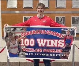  ?? Photo courtesy of St. Marys Dutchmen Wrestling ?? Waylon Wehler is shown with a banner commemorat­ing his 100th career win, which he recorded on Friday at the PIAA AA Wrestling Championsh­ip in Hershey.