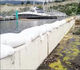  ?? JOE FRIES/Penticton Herald ?? With nothing holding it back except a concrete wall, Okanagan Lake as of Thursday afternoon was about one metre higher than the parking lot at the Penticton Yacht Club.