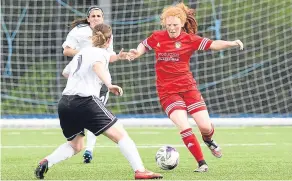  ??  ?? Jeanfield’s Ellie Cowie (red) attempts to go past her Glasgow Girls opponent in the Perth team’s 2-0 loss on the McDiarmid Park Fieldturf.