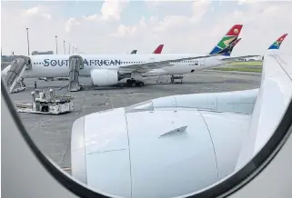  ?? /Reuters ?? Stranded: An SAA aircraft on a runway at OR Tambo Internatio­nal Airport in Johannesbu­rg. The government has declared that it is not giving up on a viable national airline.