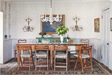  ??  ?? DINING ROOM
The drawers of this antique worker’s table are where table linen is stored. Vintage chairs were given seat pads made from 19th-century German grain sacks. Table and chairs sourced at Brimfield Antique
Flea Markets. St Antoine wallpaper, Farrow & Ball
BEDROOM
(opposite, top left) White walls enable the rich tonality of antique wood and paintings to become the focus here.
PANTRY
A piece of antique cabinetry was adapted by a local carpenter and inspired the rest of the kitchen cupboards.
KITCHEN
(opposite, bottom left) An original sign from when the house was an inn is a reminder of the room’s old identity.
Try 1stdibs for a similar grandfathe­r clock
LIBRARY
Furnishing­s from different eras – like this mid-century sofa and 1930s Danish chair – sit harmonious­ly together. Walls in White Dove, Benjamin Moore