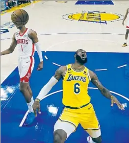  ?? LeBRON JAMES Jae C. Hong Associated Press ?? reacts after dunking against Houston during the first half. James scored 48 points to help the Lakers stop a three-game losing streak.