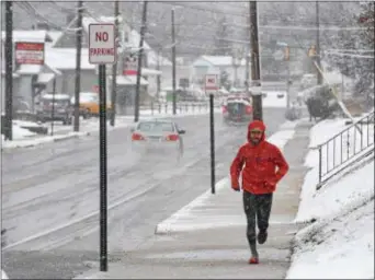  ?? PETE BANNAN — DIGITAL FIRST MEDIA ?? David Stango of Bethel goes for his morning run along Chichester Avenue Wednesday morning. “Gotta get the run in,” Stango said.