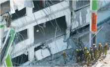  ?? (Nir Elias/Reuters) ?? RESCUE PERSONNEL search through the rubble after a building site collapsed in Tel Aviv last September.