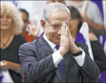  ?? Oded Balilty The Associated Press ?? Israeli Prime Minister Benjamin Netanyahu reacts after delivering a statement Saturday in Petah Tikva. Netanyahu said his opponents tried to “steal the elections.”
