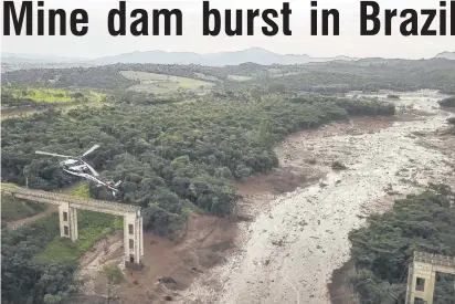  ??  ?? Devastatio­n . . . A helicopter looks for survivors of a landslip yesterday after the collapse of a dam at an ironore mine belonging to Brazil’s giant mining company Vale in Corrego do Feijao near the town of Brumadinho.