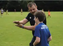  ??  ?? Corey Carty gives instructio­ns at a King’s Hospital camp