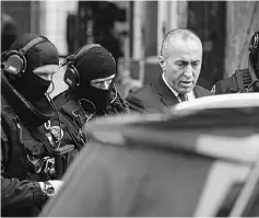  ?? — AFP photo ?? Former Kosovo Prime Minister Ramush Haradinaj leaves the prison of Colmar, surrounded by police officers.