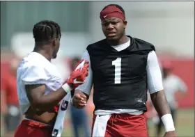  ?? (NWA Democrat-Gazette/Andy Shupe) ?? Arkansas quarterbac­k KJ Jefferson (right), seen here during an Aug. 6 practice in Fayettevil­le, threw a 50-yard touchdown pass to Kendall Catalon on Saturday in the Razorbacks’ first scrimmage of the fall. Jefferson and the first-team offense took about 50 snaps in the scrimmage, which was closed to the public and media.