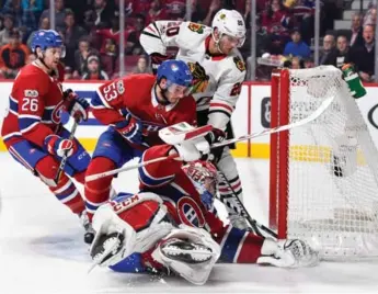  ?? MINAS PANAGIOTAK­IS/GETTY IMAGES ?? Rookie Victor Mete, who played his way onto the Canadiens blue line with a strong camp, has goalie Carey Price’s back with Brandon Saad of the Blackhawks ready to pounce in Montreal’s home opener on Tuesday.