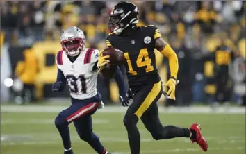  ?? Associated Press ?? Steelers receiver George Pickens catches a pass as Patriots cornerback Jonathan Jones defends during the second half Thursday at Acrisure Stadium.
