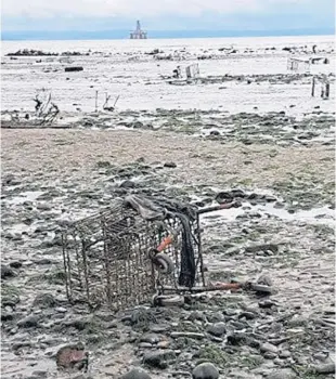  ??  ?? Abandoned supermarke­t trolleys and traffic cones on Leven beach.