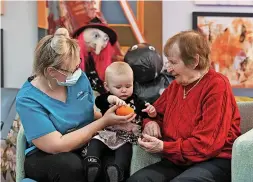  ?? ?? Staff member Amy Gore introduces her baby Delilah to resident Maria