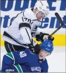  ?? The Canadian Press ?? Los Angeles Kings’Tanner Pearson checks Vancouver Canucks’ Elias Pettersson in the head during Thursday’s first period.