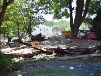  ?? MARIAN DENNIS — MEDIANEWS GROUP ?? The backyards of several residences on Lumber Street in Green Lane were torn apart by flooding Thursday night. Here, a resident’s back deck has been completely destroyed in the storm.