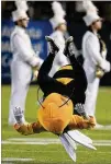  ?? CURTIS COMPTON / AJC 2015 ?? Georgia Tech mascot Buzz does a flip, his Chuck Taylor All-Stars clearly visible as he does so.