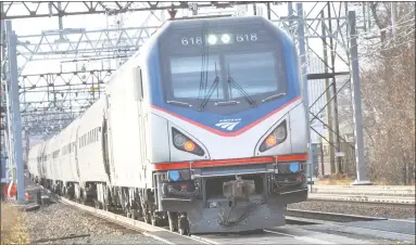  ?? Alex von Kleydorff / Hearst Connecticu­t Media file photo ?? An Amtrak train passes through Norwalk in December 2016. Amtrak this week said it will discontinu­e offering discounts to military veterans and their families.