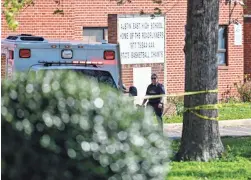  ?? WADE PAYNE/AP ?? A member of the Knoxville police forensics team works the scene of a shooting at Austin-East Magnet High School in Knoxville, Tenn., Monday.