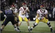  ?? ELAINE THOMPSON — THE ASSOCIATED PRESS FILE ?? In this file photo, Southern California quarterbac­k Sam Darnold takes a snap during the team’s NCAA college football game against Washington in Seattle. USC is in the No. 4 spot in The Associated Press’ preseason poll. Darnold, the Heisman Trophy...