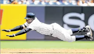  ?? Getty Images ?? TAKING FLIGHT: Didi Gregorius slides head first into second base in the second inning of the Yankees’, 4-1, loss to the Orioles in The Bronx on Thursday afternoon.