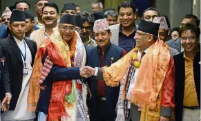  ??  ?? Political cycle: Deuba (left) shaking hands with outgoing prime minister Pushpa Kamal Dahal in Kathmandu in June. — AFP