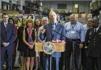  ?? BRUCE R. BENNETT / THE PALM BEACH POST ?? Joined by employees of Cheney Brothers Inc., a food distributo­r, Gov. Rick Scott discusses his 2018 budget proposal at a news conference Monday in Riviera Beach.