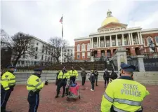  ?? NICOLAUS CZARNECKI / HERALD STAFF FILE ?? ON THE LOOKOUT: State Police step in to calm the situation as a person with a camera and a bystander get into a scuffle as dozens gathered for a Trump Lost! Fascists Get Out! Rally and March outside the State House on Jan. 5. Police are on the alert for more trouble.