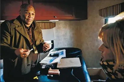  ?? AMY DAVIS/BALTIMORE SUN PHOTOS ?? Thomas Clemons teaches Susie McGuire how to use naloxone to reverse a heroin overdose in a city needle-exchange van. McGuire, 42, who suffered an overdose herself and lost jobs and her home to addiction, hopes the training will enable her to help others.