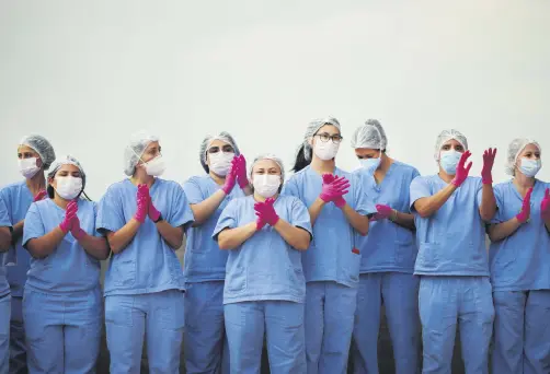  ??  ?? Health care workers celebrate as the last COVID-19 patients leave a temporary field hospital in Brasilia, Brazil, Oct. 15, 2020. (Reuters Photo)