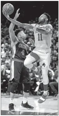  ?? NWA Democrat-Gazette/BEN GOFF ?? Arkansas guard Keyshawn Embery-Simpson shoots as Ole Miss guard Breein Tyree defends in the Razorbacks’ 74-73 victory over Ole Miss on Saturday. Arkansas has played five one-point games this season and has won three of them.