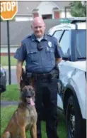  ??  ?? Officer Christophe­r Wienczek stands with new K-9 partner, “Rambo.” Rambo is trained in narcotics detection and patrol.