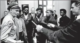  ?? (File Photo/AP) ?? Members of the Black Panther Party Eldridge Cleaver (left, in sunglasses) and Bobby Seale argue with a California state policeman May 2, 1967, at the Capitol in Sacramento after he disarmed them. The armed Panthers entered the Capitol protesting a bill before the Legislatur­e that would restrict carrying arms in public.