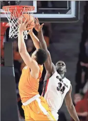  ?? Joshua L. Jones /
AP ?? Tennessee’s Grant Williams (left) has his shot blocked by Georgia’s Derek Ogbeide during Saturday’s game.