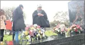  ?? PICTURE: COURTNEY AFRICA ?? IN MEMORIAM: Michelle Assure and others pay tribute to Ashley Kriel at his grave as they commemorat­e the 30th anniversar­y of his death.