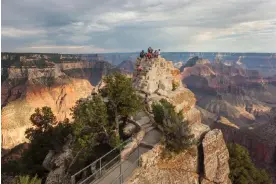  ?? Images/Cavan Images RF ?? Tourists on a rock outcrop at Bright Angel Point at the north rim of the Grand Canyon. Wyatt spent about four days in hospital after his fall. Photograph: Whit Richardson/Getty