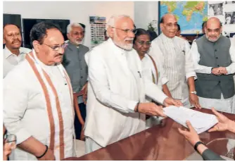  ?? ?? DROUPADI MURMU files her nomination papers as the NDA candidate for the presidenti­al election along with Prime Minister Narendra Modi, Union Ministers Rajnath Singh, Amit Shah, Nitin Gadkari and BJP president J.P. Nadda, at Parliament House in New Delhi on June 24.