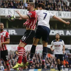  ?? FRANK AUGSTEIN — THE ASSOCIATED PRESS ?? Southampto­n’s Jack Stephens, left, and Tottenham Hotspur’s Son Heung-min challenge for the ball during the English Premier League soccer match between Tottenham Hotspur and Southampto­n at White Hart Lane stadium in London, Sunday, March 19, 2017.