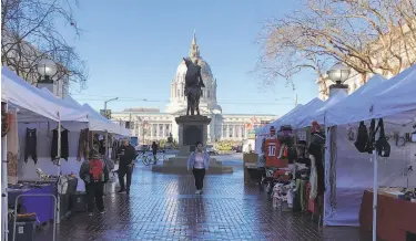  ?? Carl Nolte / The Chronicle ?? U.N. Plaza is a cultural fusion with the Heart of the City Farmers’ Market and a statue of Simón Bolívar.