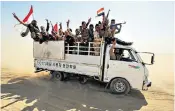  ??  ?? Civilians evacuate as forces advance towards an Isil stronghold in the city of Hawijah in Kirkuk, top; fighters of the Hashed al-Shaabi paramilita­ries during the fight against Isil, above