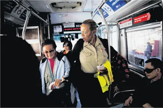 ??  ?? No matter what route she drives, Linda Wilson-Allen gets to know many of her regular passengers, including Diana Cheng. Wilson-Allen has 26 years of service.