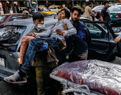  ?? Victor J. Blue / New York Times ?? A person wounded in one of the suicide bomb attacks near the airport in Kabul, Afghanista­n, arrives at a hospital there. Western officials had warned of a major attack in Kabul, urging people to leave the airport.