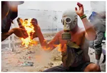  ?? ?? Above: Fires rage at the Brazil border. Left: A Molotov cocktail burns