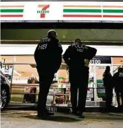  ?? Chris Carlson / Associated Press ?? U.S. Immigratio­n and Customs Enforcemen­t agents serve an employment audit notice at a 7-Eleven convenienc­e store Wednesday in Los Angeles.