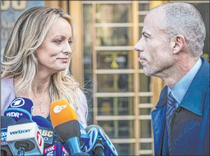  ?? Mary Altaffer The Associated Press ?? Stormy Daniels attends a news conference with her one-time lawyer, Michael Avenatti. Daniels, a former adult film star, is front and center in a case involving former President Donald Trump.