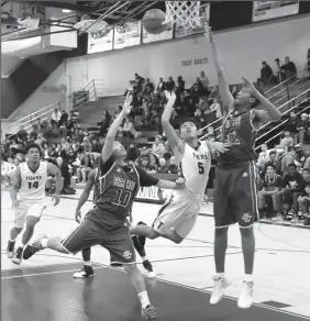  ?? COURTESY PHOTO/KEITH COLGAN PHOTOGRAPH­Y ?? Tokay’s Austin Dongon (5) takes a shot between Bear Creek’s Nick To (10) and Cameron McCants (12) during Tokay’s victory on Tuesday at The Jungle.