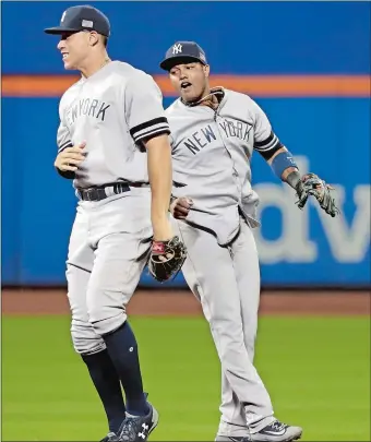  ?? FRANK FRANKLIN II/AP PHOTO ?? Aaron Judge, left, and Starlin Castro celebrate the Yankees’ 5-1 win over Tampa Bay on Monday night.