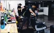  ??  ?? Robin Rahman, 29, cleans up at the Grizzly Barber Shop in Merced, which was allowed to operate in the purple tier.